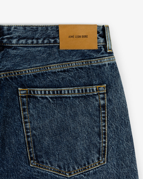 Close-up of the back pocket and leather label on the Relaxed Fit 5-Pocket Denim Pant by Aimé Leon Dore.