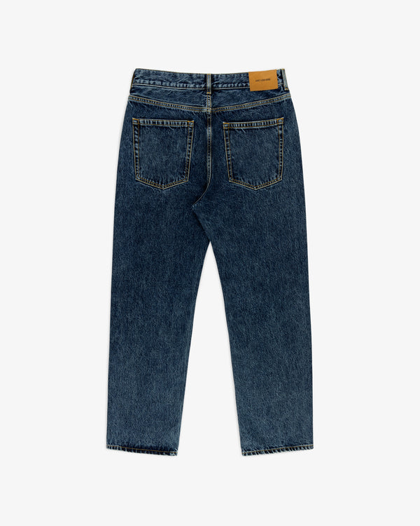 Back view of Relaxed Fit 5-Pocket Denim Pant in blue with two back pockets and tan leather patch on waistband, laid flat.