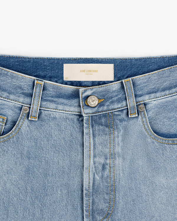 Close-up of Relaxed Fit 5-Pocket Denim Pant in light blue with metal button, front pockets, and belt loops.