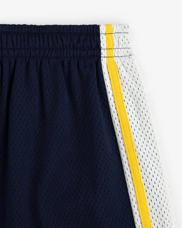 Close-up of Colorblock Court Short: navy blue mesh, white side panel, yellow stripe, and elastic waistband.
