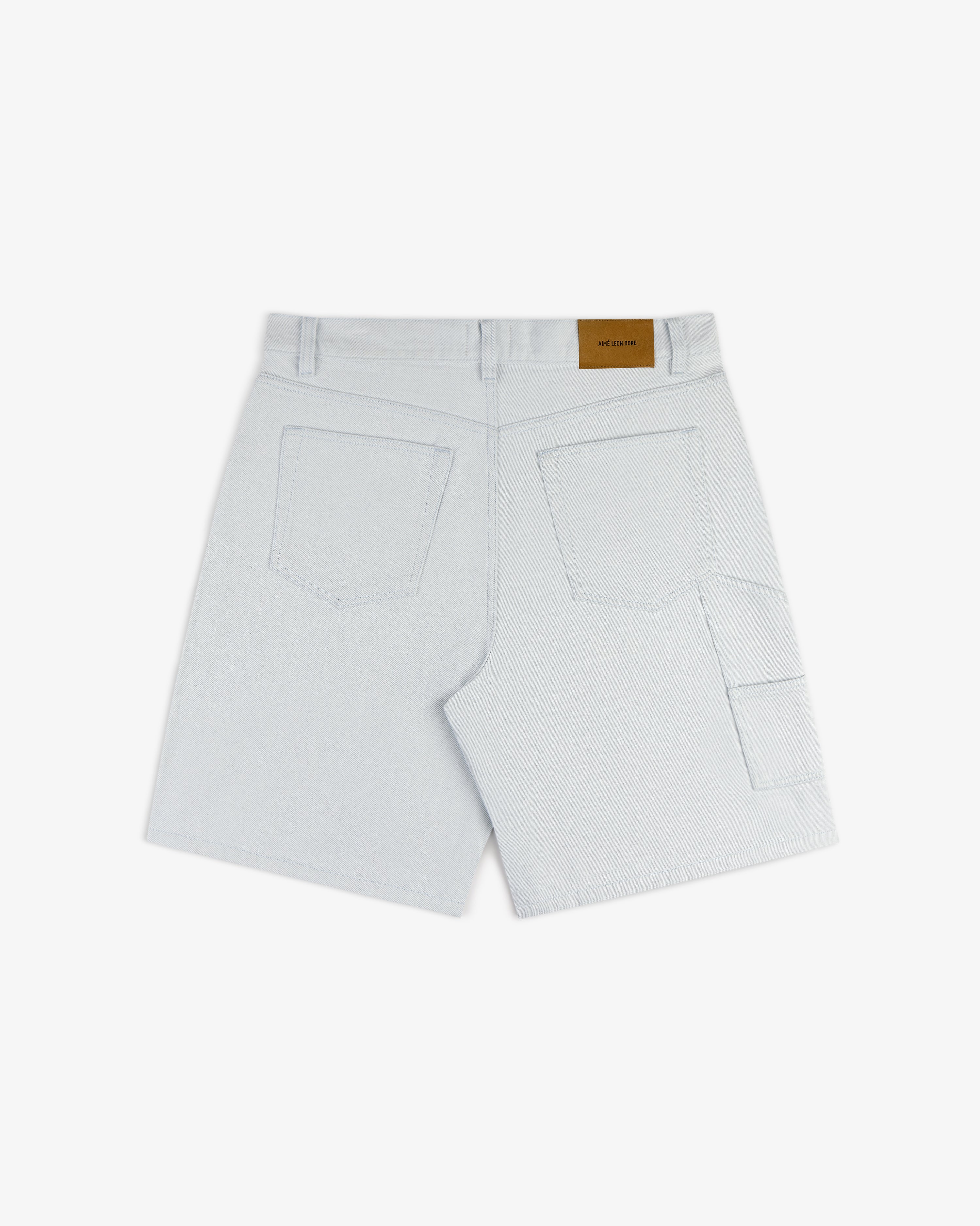 Back view of Light Wash Denim Short with two large back pockets and a brown patch label on the waistband.