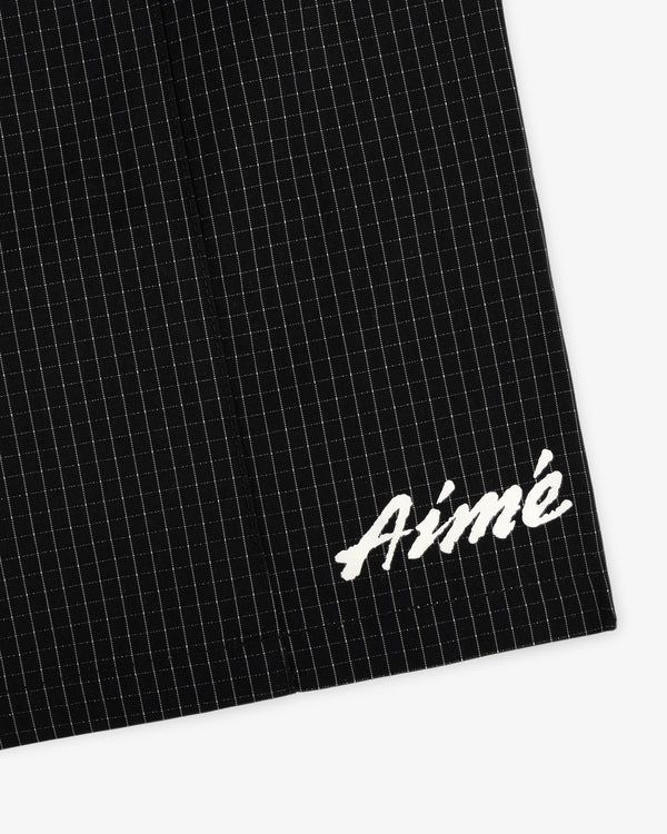 Black Ripstop Nylon Wave Short with a subtle grid and white embroidered Aimé in the bottom right corner.