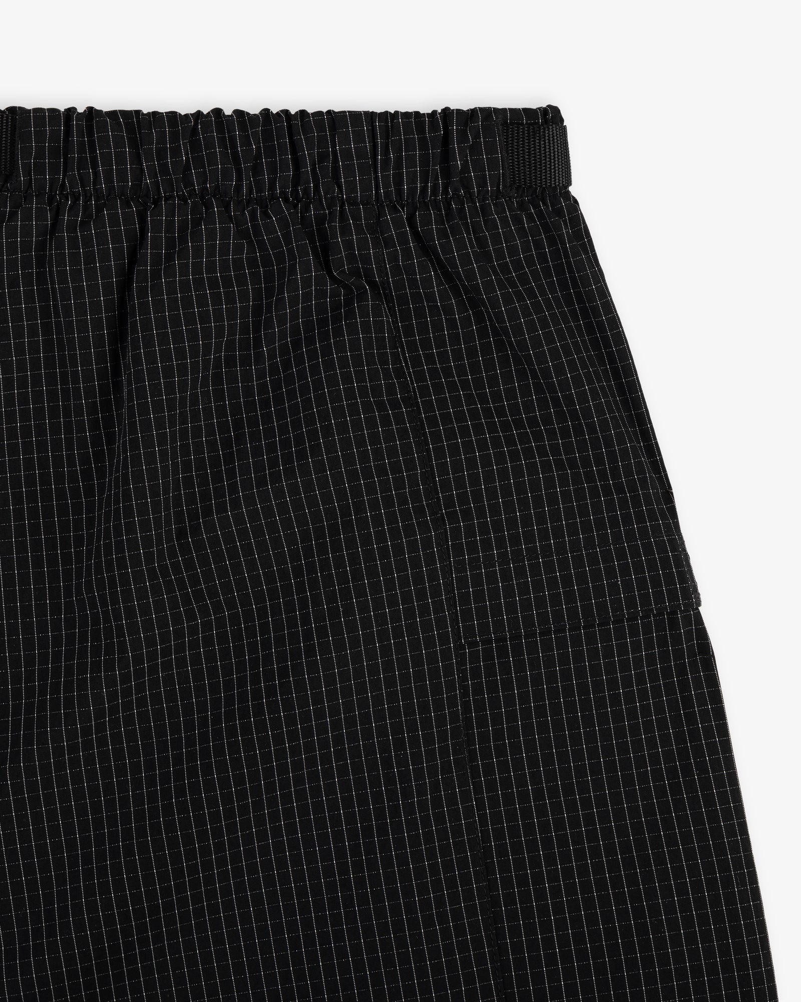 Close-up of Ripstop Nylon Wave Short in black with elastic waistband and white grid pattern.