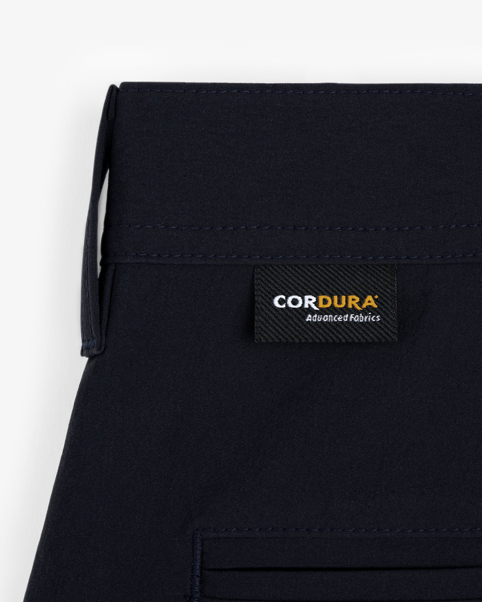 Close-up of ALD Golf Cordura Double Pleated Short with a black “CORDURA Advanced Fabrics” label above the pocket.