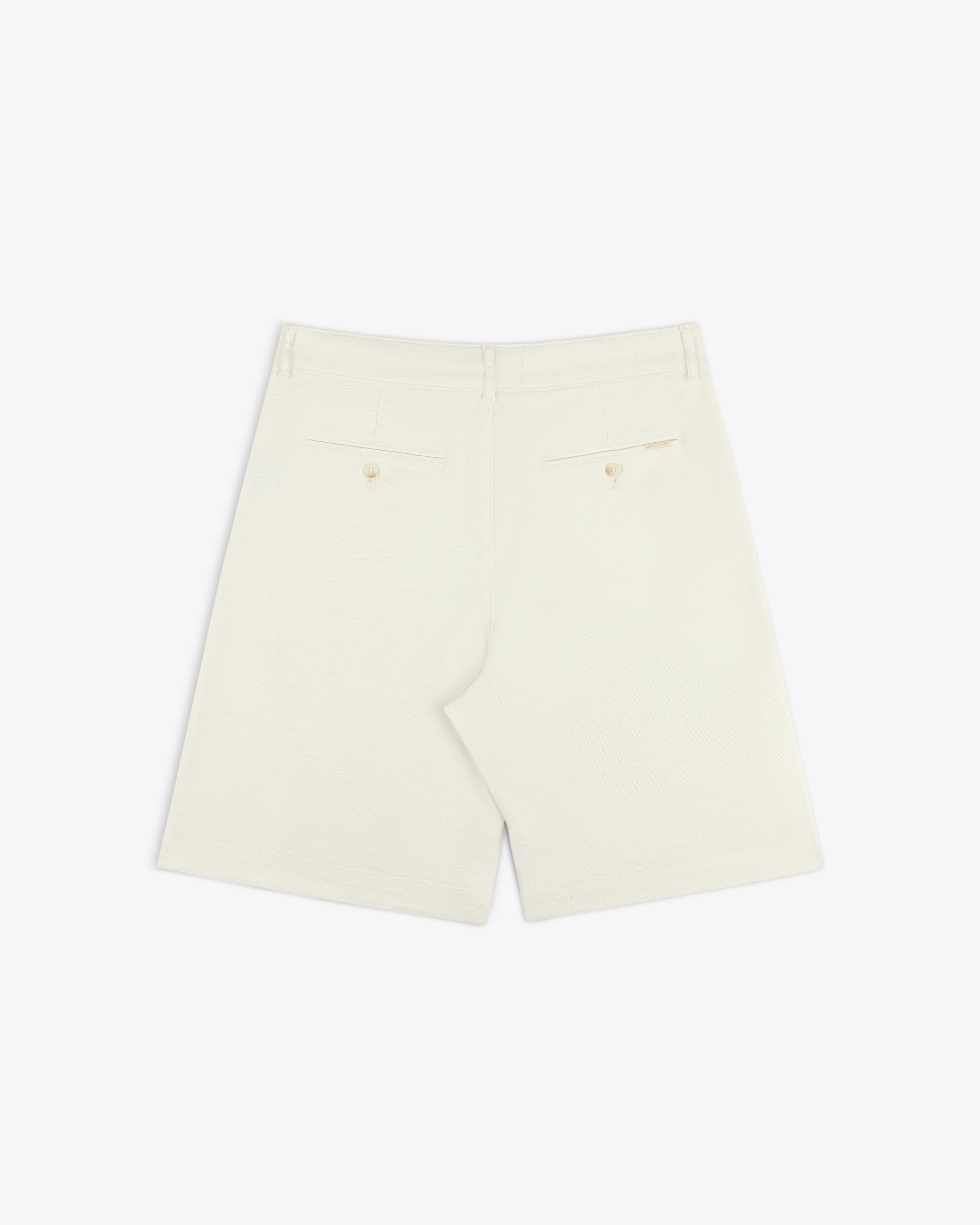 Back view of Pleated Linen Blend Bermuda Short in cream with two back pockets and buttons, shown on white background.