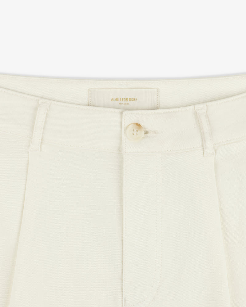 Close-up of Pleated Linen Blend Bermuda Short in cream with a single button and belt loops at the waistband.