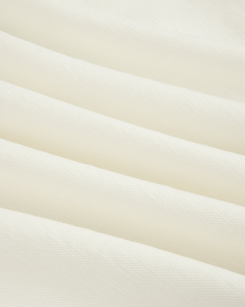 Close-up of Pleated Linen Blend Bermuda Short in white, featuring soft fabric with gentle horizontal folds.