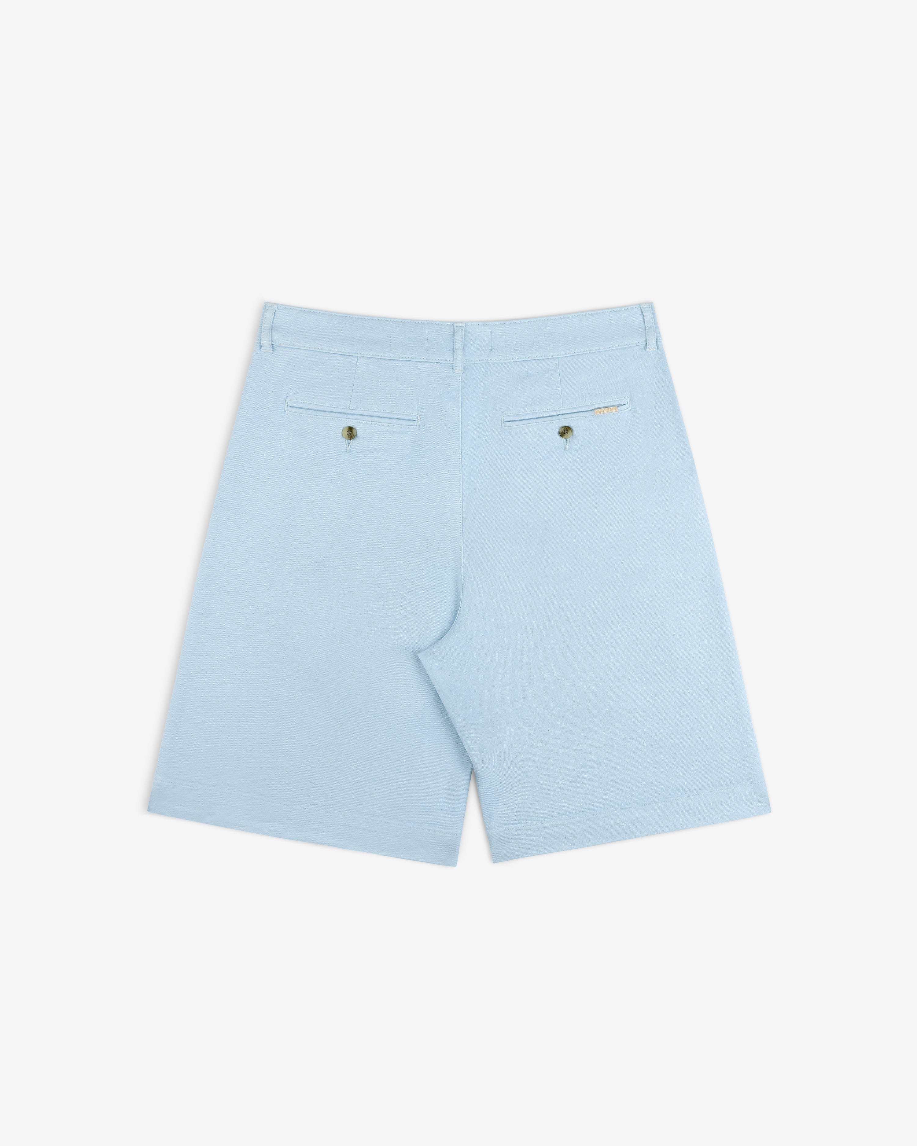 Pleated Linen Blend Bermuda Short in light blue, shown from the back with buttoned rear pockets and a tag above the right.