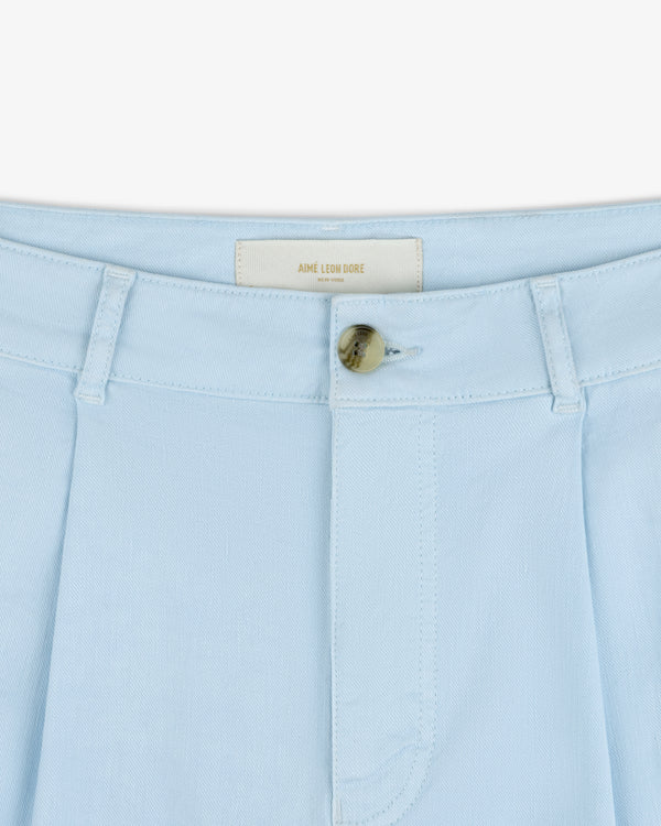 Close-up of Pleated Linen Blend Bermuda Short in light blue with belt loops, button closure, and AIME LEON DORE label.