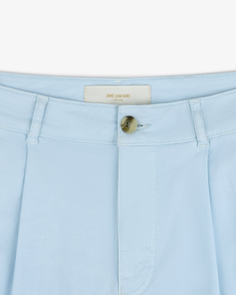 Close-up of Pleated Linen Blend Bermuda Short in light blue with belt loops, button closure, and AIME LEON DORE label.
