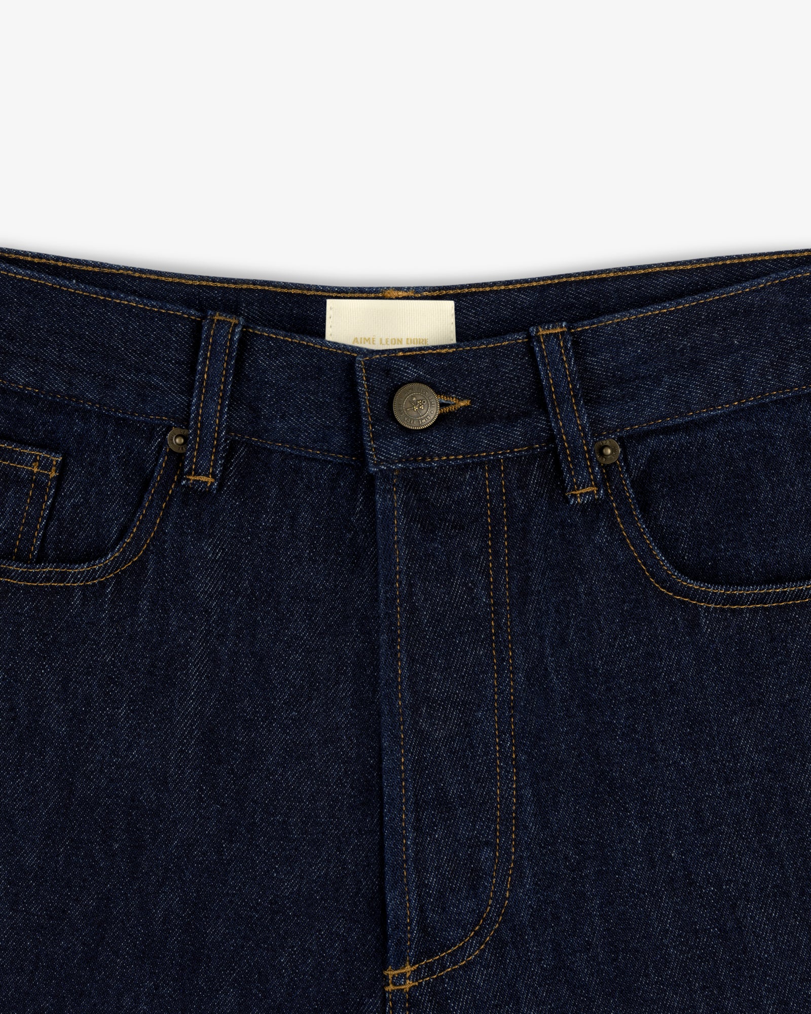 Close-up of the waistband and button of Rinse Wash Denim Short with yellow stitching.