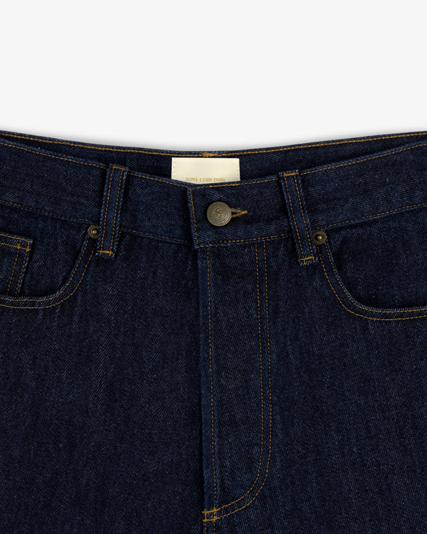 Close-up of the waistband and button of Rinse Wash Denim Short with yellow stitching.