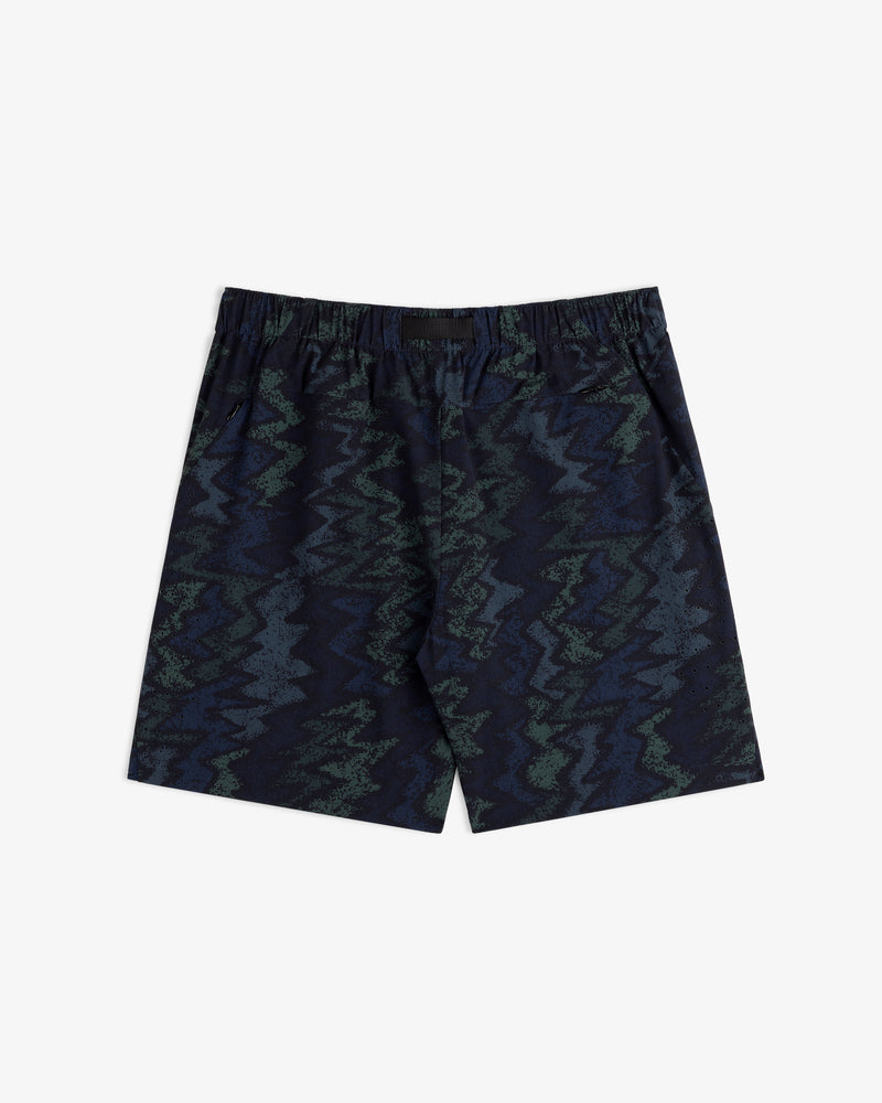 ALD Golf Performance Short in navy blue with a green and blue zigzag abstract pattern on a white background.