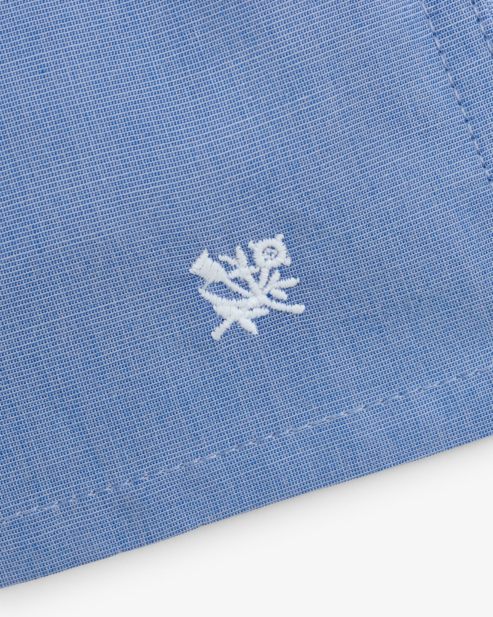 Close-up of blue Boxer Short 2-Pack with a small white embroidered flower and leaf near the edge.