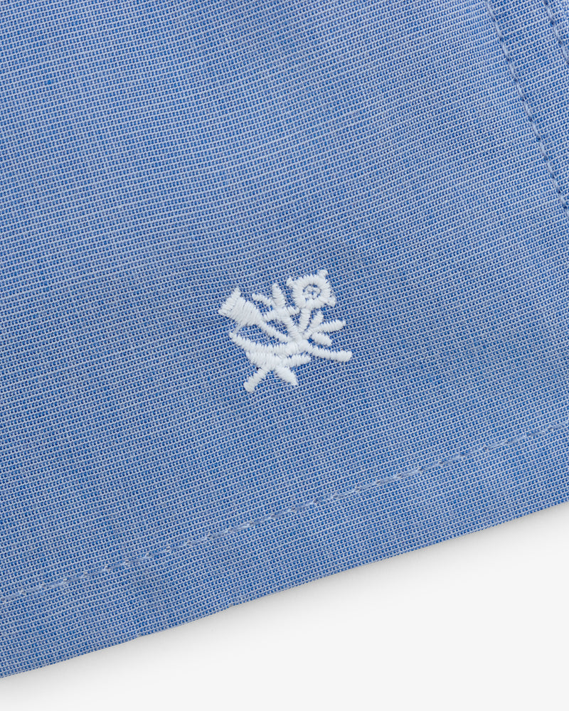 Close-up of blue Boxer Short 2-Pack with a small white embroidered flower and leaf near the edge.