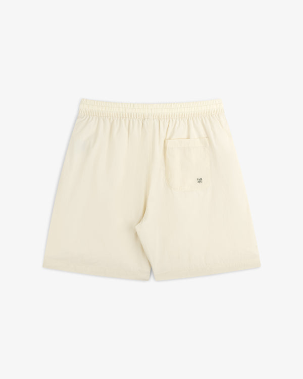 Back view of cream Long Nylon Track Short with elastic waistband and a single right back pocket.
