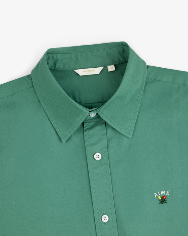 Leon Overshirt in green, size M, with AIMÉ and a small flower embroidered on the chest.