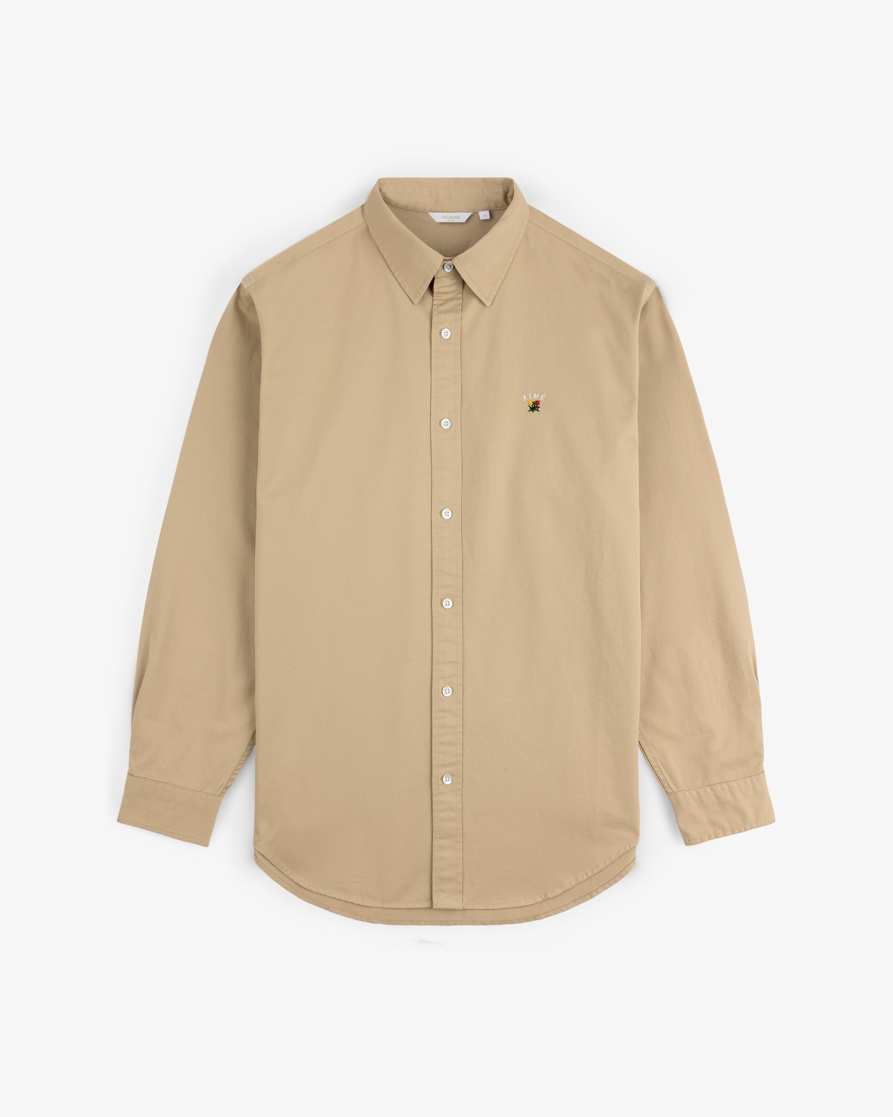 Leon Overshirt in beige, long-sleeve with button-up front and small embroidered bee on left chest, shown on white background.