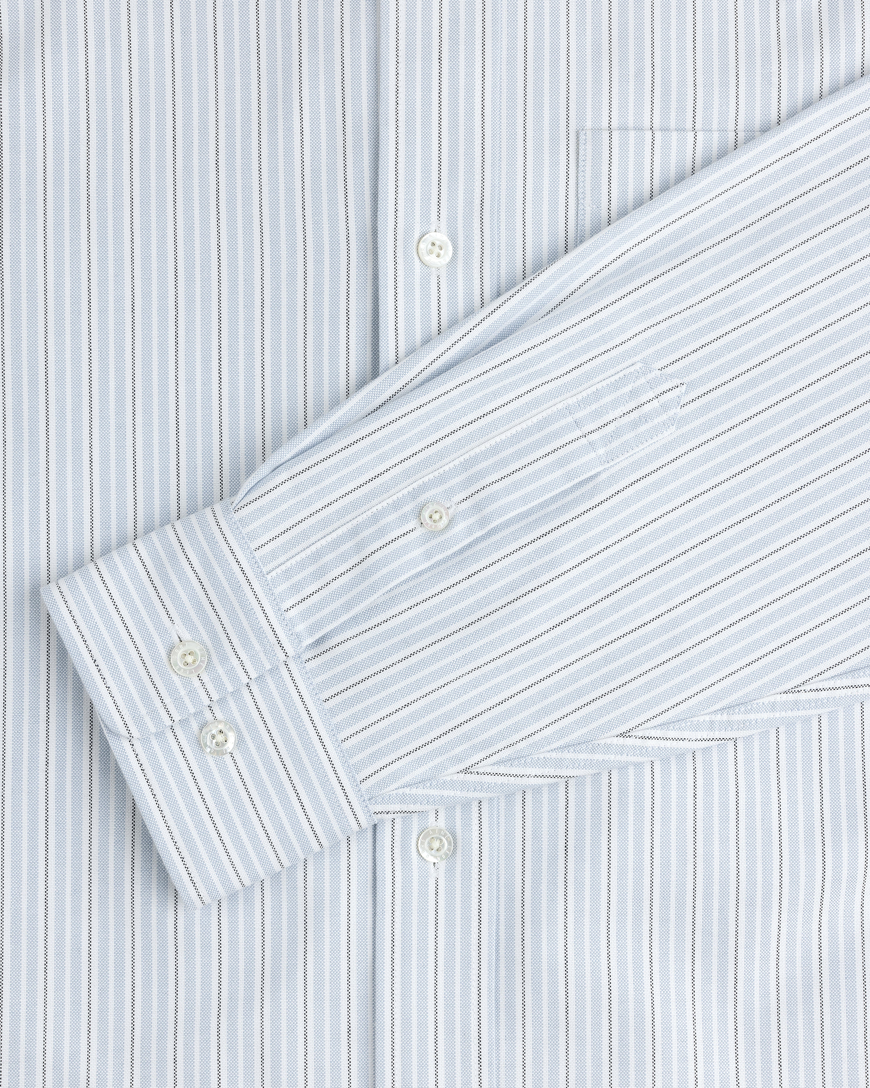 Yarn Dyed Striped Crest Shirt in light blue and white with visible buttons and a chest pocket.