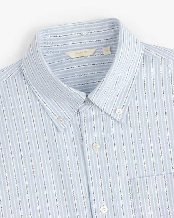 Yarn Dyed Striped Crest Shirt in light blue and white with a collar and front pocket, shown flat.
