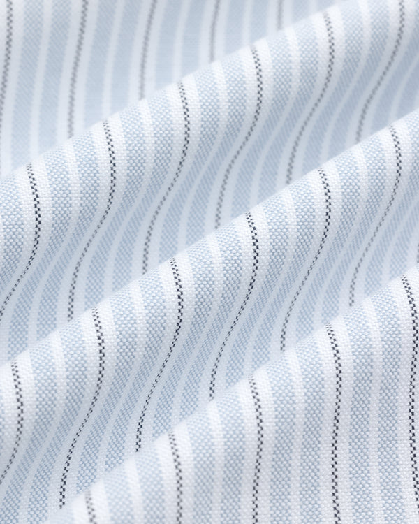 Close-up of the Yarn Dyed Striped Crest Shirt’s white fabric with light blue and black vertical pinstripes.