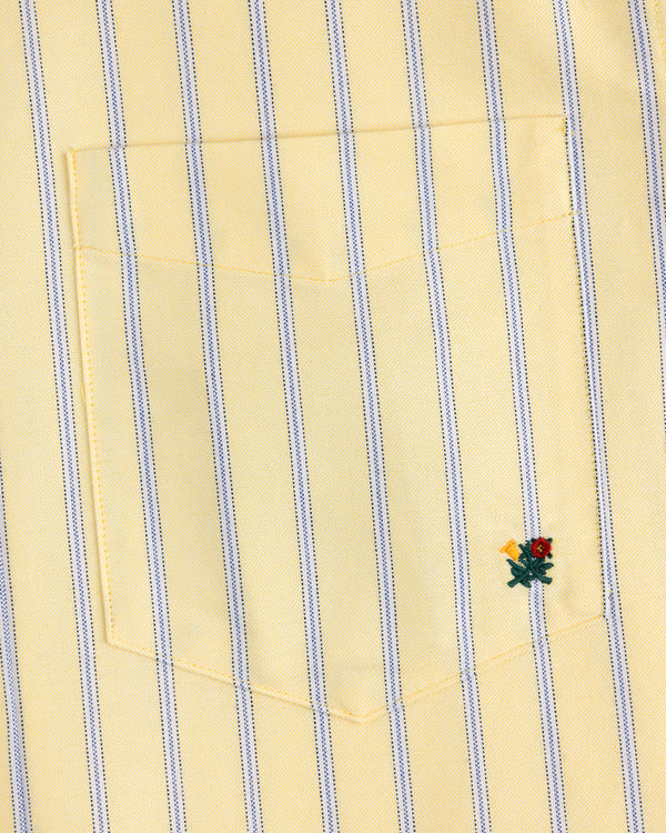 Yarn Dyed Striped Crest Shirt: yellow with blue stripes, pocket, and a small red-yellow embroidered flower at the bottom right.