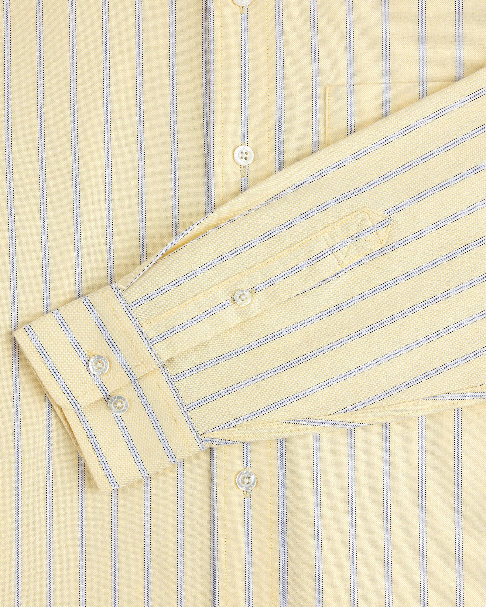Yarn Dyed Striped Crest Shirt in yellow with blue stripes, close-up of sleeve, buttons, and pocket.