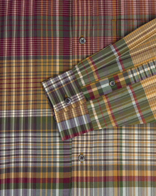 A close-up of the Washed Madras Shirt featuring yellow, green, brown, and red plaid with visible buttons.