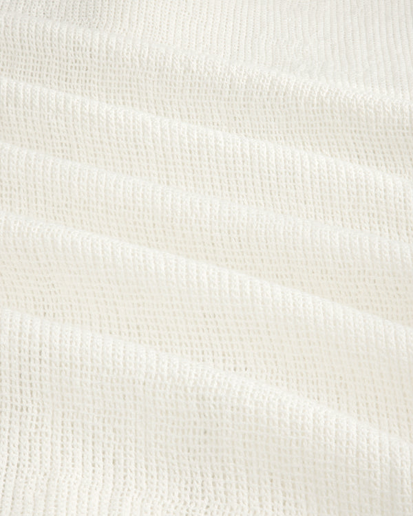 Close-up of the Mesh Jungle Shirt's white waffle-textured fabric with soft, grid-like ridges.