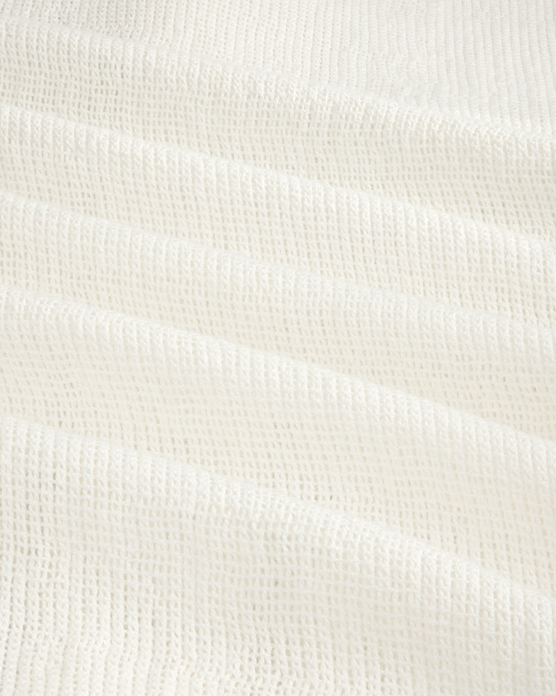 Close-up of the Mesh Jungle Shirt's white waffle-textured fabric with soft, grid-like ridges.