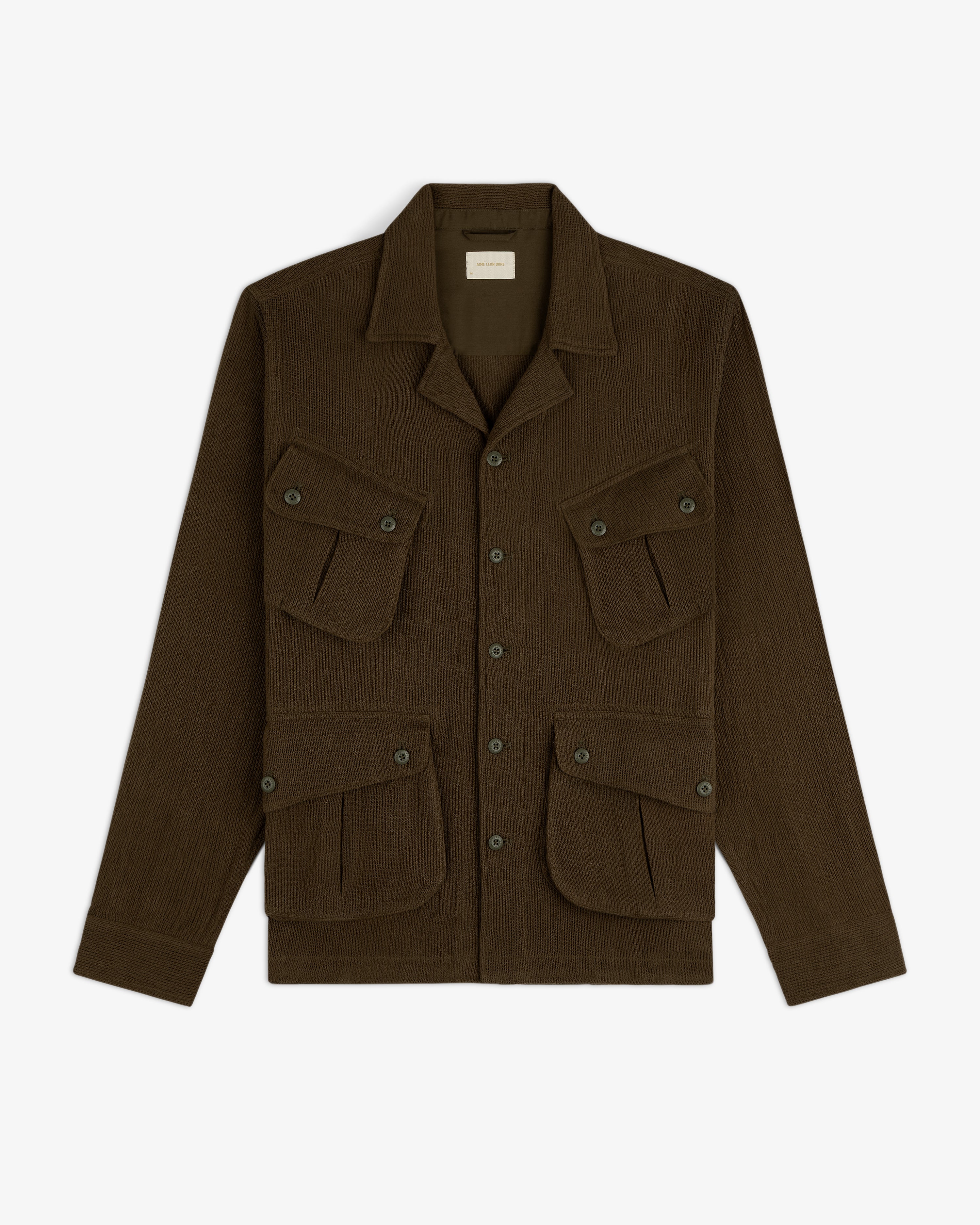 Mesh Jungle Shirt with a collar and four front buttoned flap pockets, laid flat on a white background.