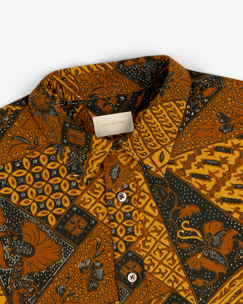 A close-up of the Printed Abstract Shirt featuring gold, black, and brown geometric and floral patterns.