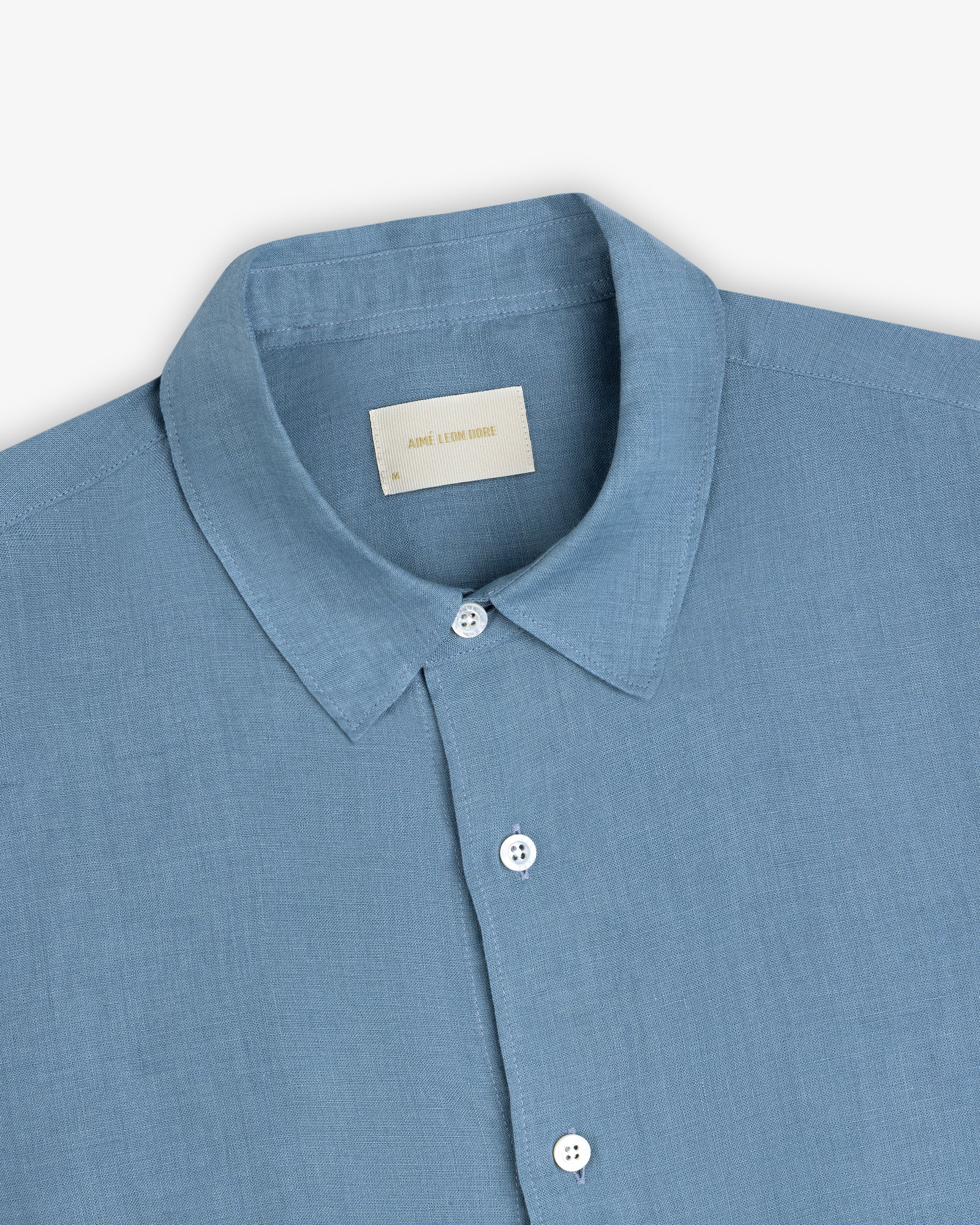 Light blue Long-Sleeve Linen Shirt with a pointed collar, white buttons, and visible neck label on plain background.