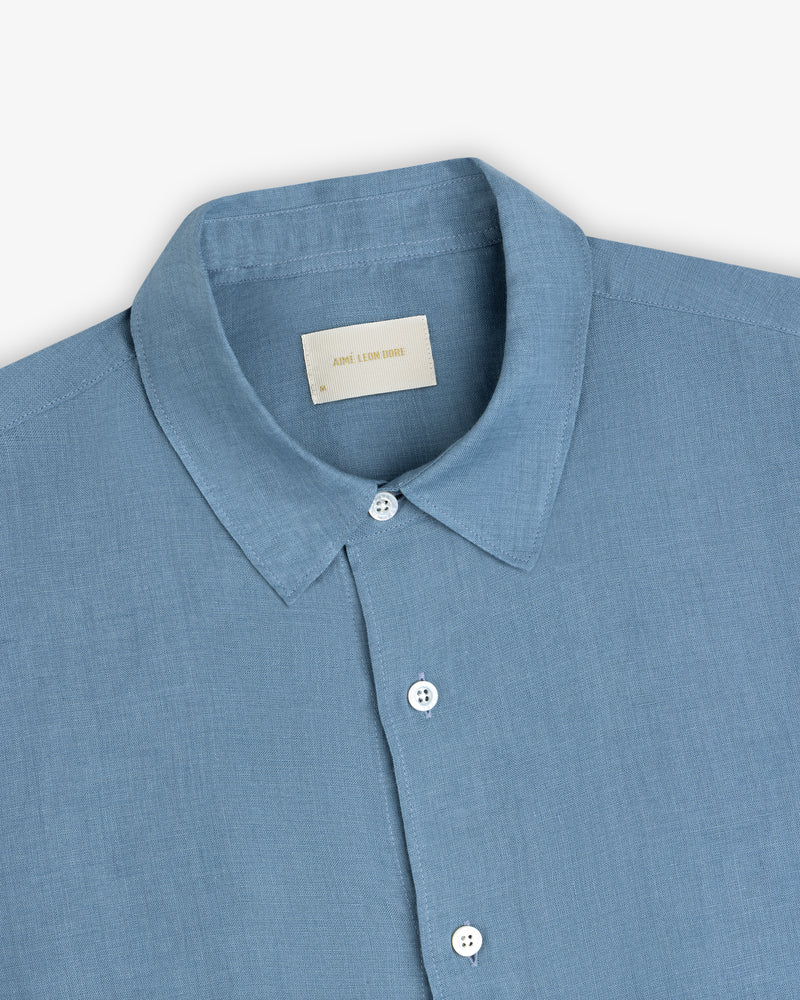Light blue Long-Sleeve Linen Shirt with a pointed collar, white buttons, and visible neck label on plain background.