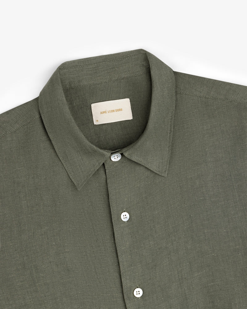 Olive green Long-Sleeve Linen Shirt with white buttons, folded on a white background.