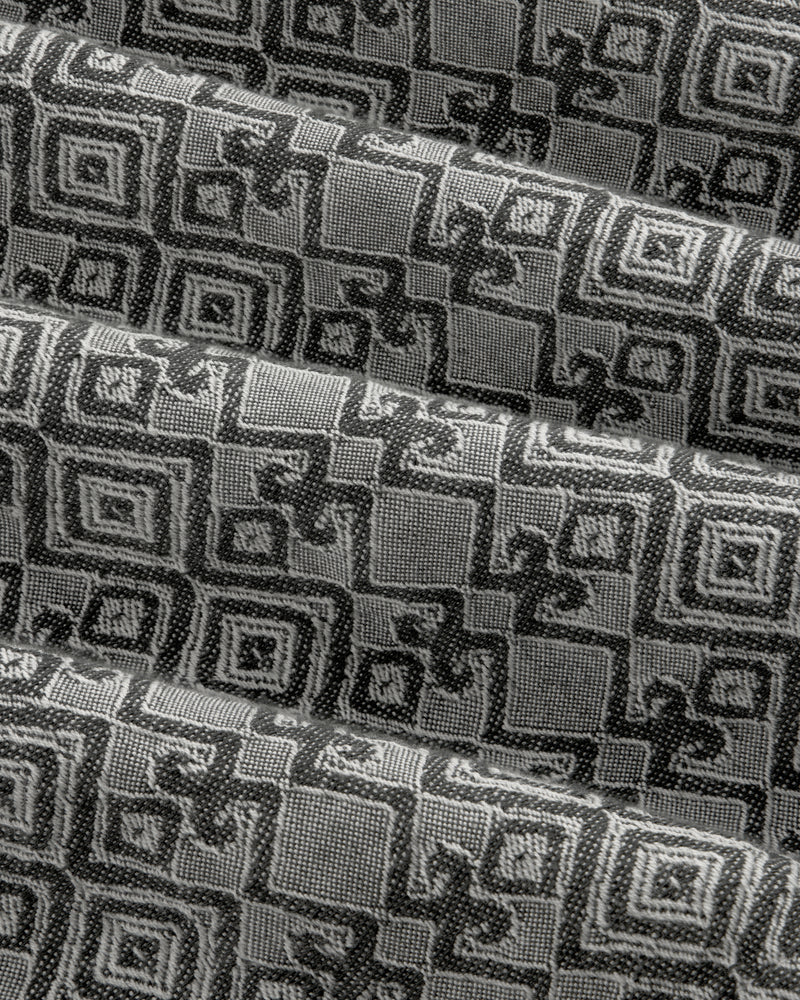 Jacquard Leisure Shirt in black and gray fabric features a geometric square pattern, shown with overlapping folds.