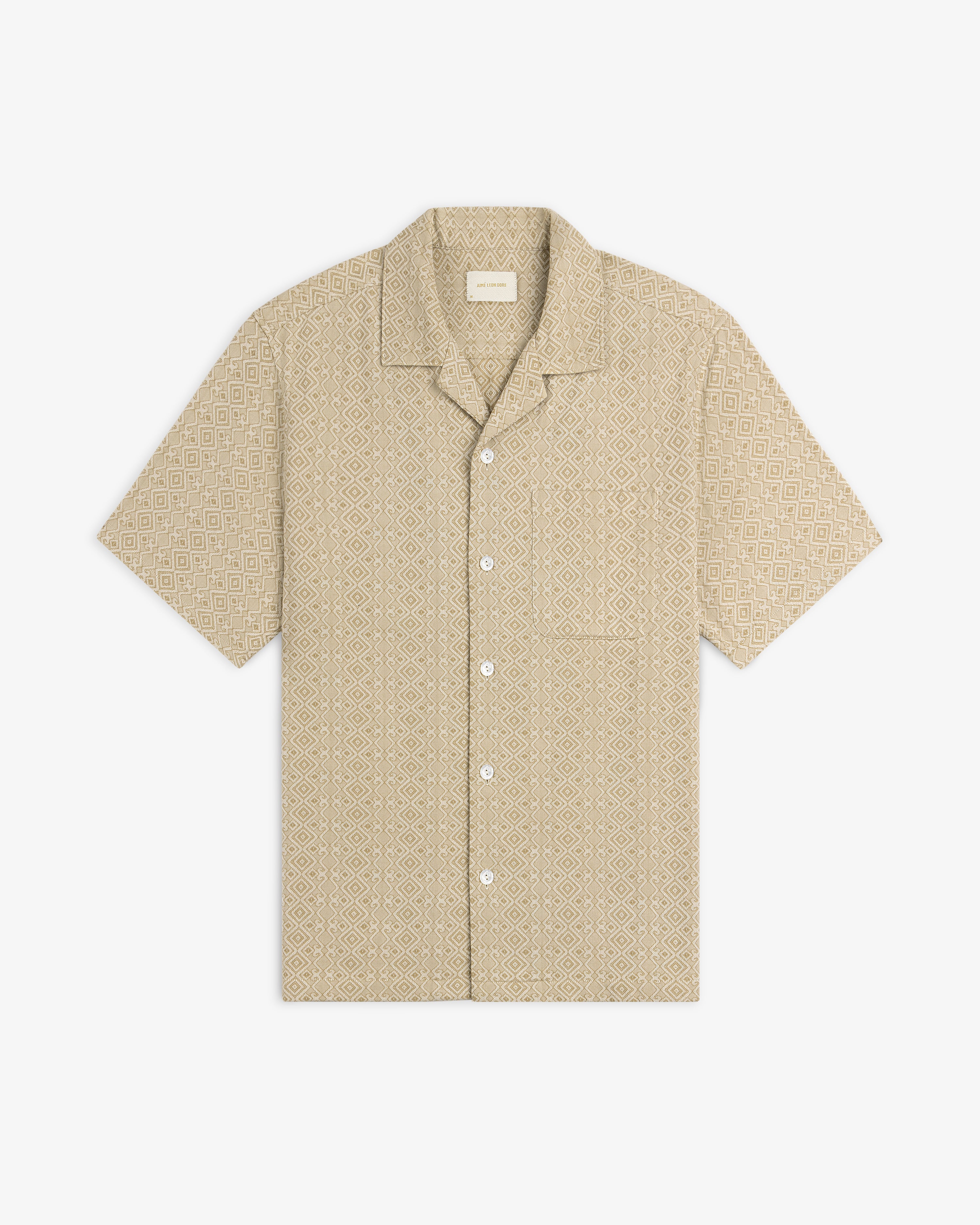 Jacquard Leisure Shirt in beige with short sleeves and subtle geometric diamond pattern, shown on a white background.