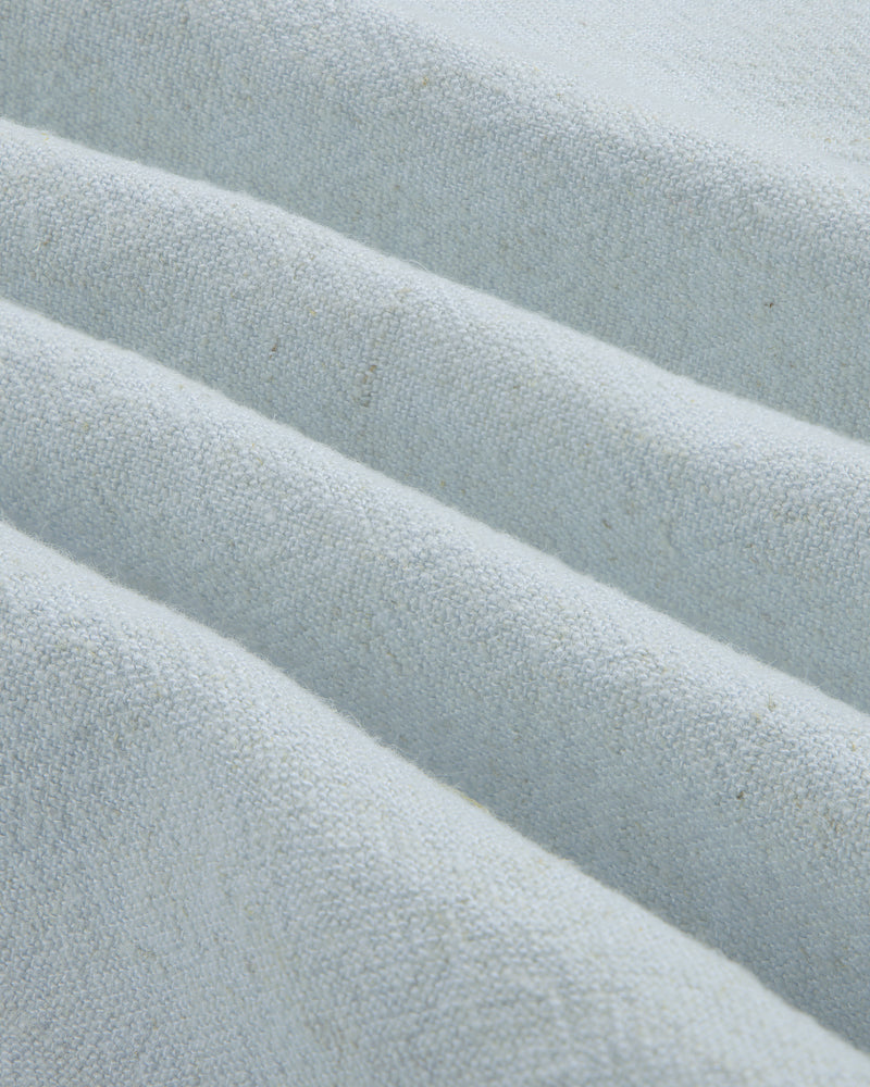 Close-up of the Linen Blend Leisure Shirt's textured light gray fabric with soft diagonal folds.