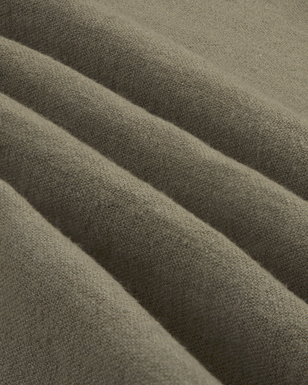 Close-up of folded, textured olive green Linen Blend Leisure Shirt with visible weave and soft ridges.