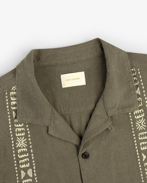 Olive green Linen Blend Leisure Shirt with cream embroidery and a visible inner label on a white background.