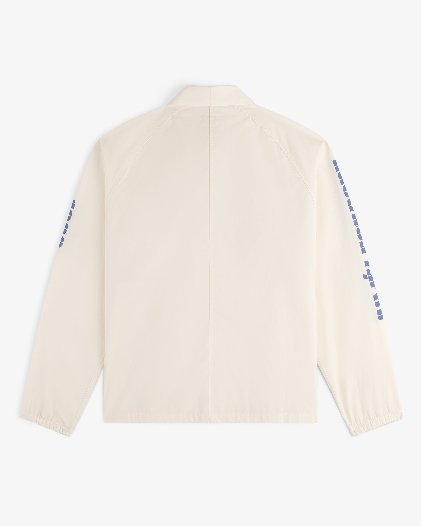 Back view of the Marina Jacket, a light beige long-sleeve with blue square designs on the sleeves.