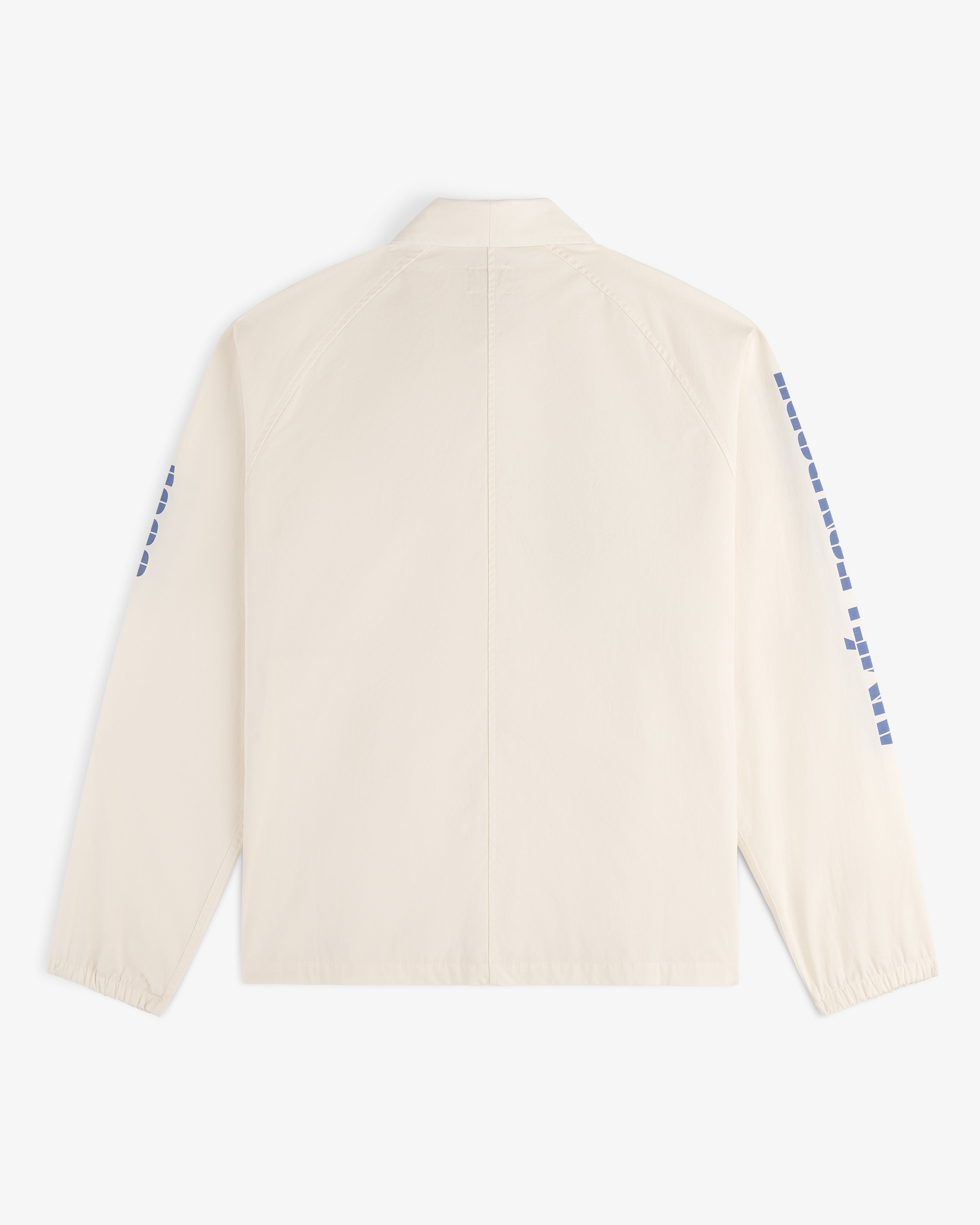 Back view of the Marina Jacket, a light beige long-sleeve with blue square designs on the sleeves.
