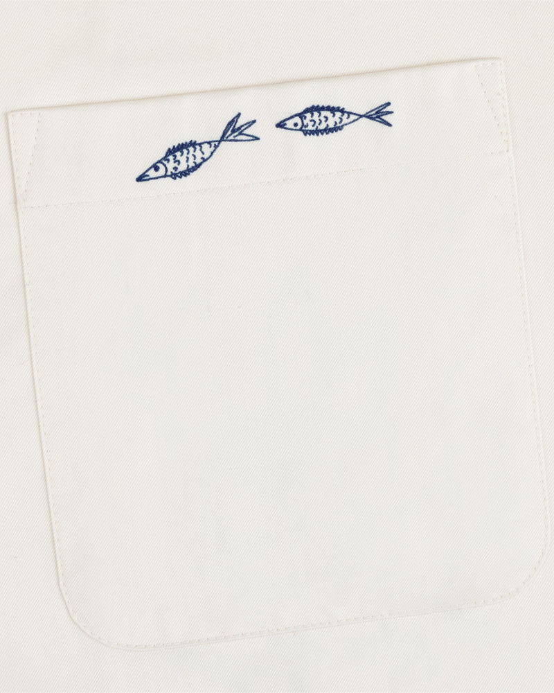 The Fassianos "Rendez-Vous" Camp Shirt features a white fabric pocket with two small blue fish above the opening.