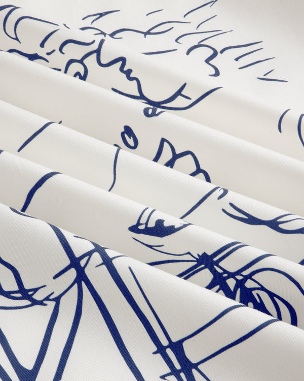 Fassianos "Rendez-Vous" Camp Shirt: white fabric with blue abstract face line art, draped in soft folds.