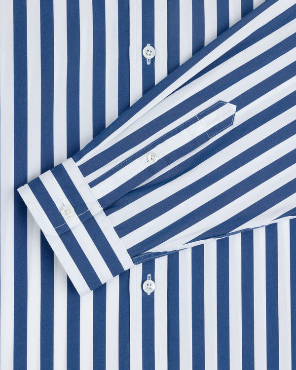 Striped Leon Overshirt in blue and white vertical stripes with folded sleeves and white cuff buttons.