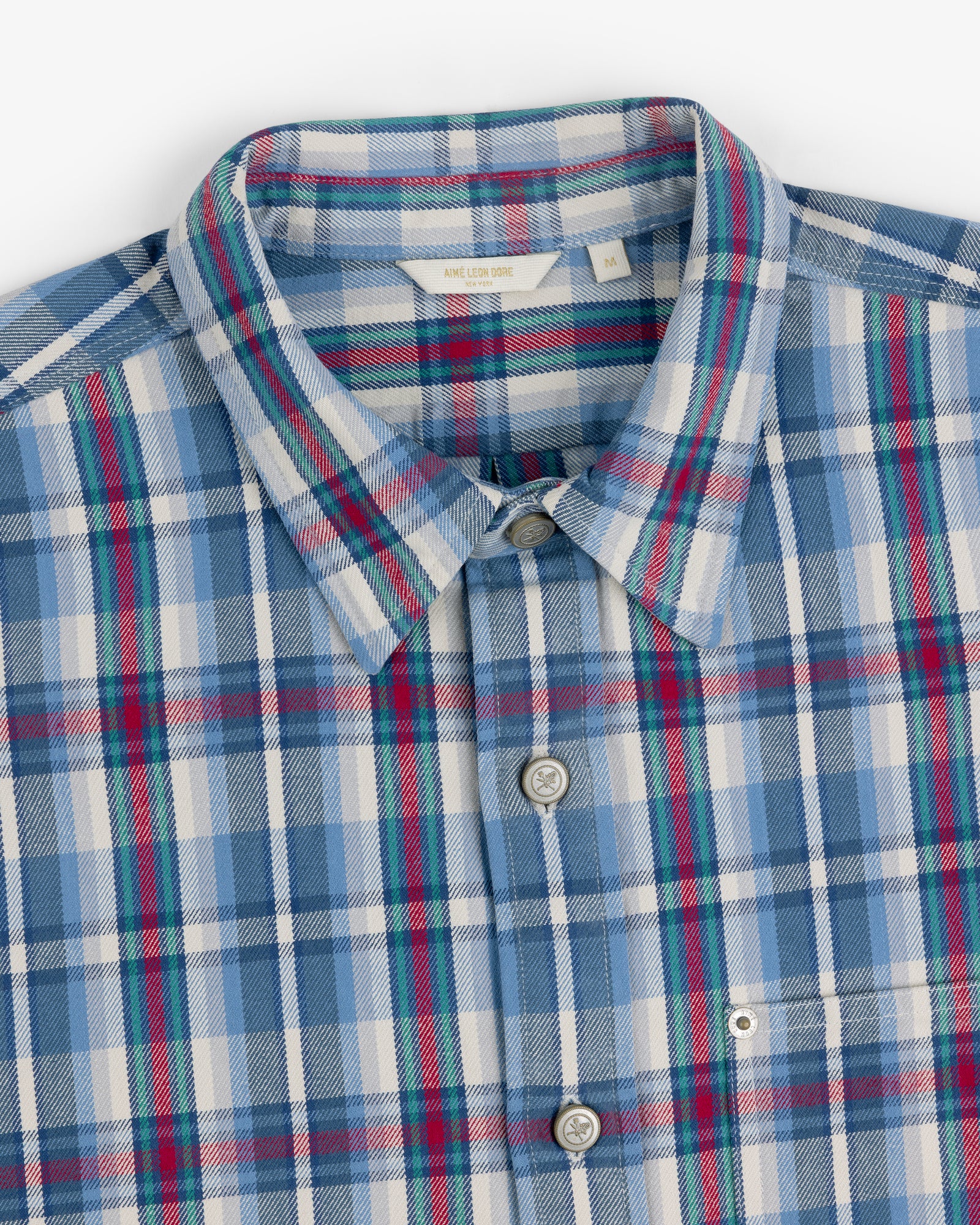 Plaid Work Shirt in blue, white, red, and green, neatly folded to display the collar and buttons.