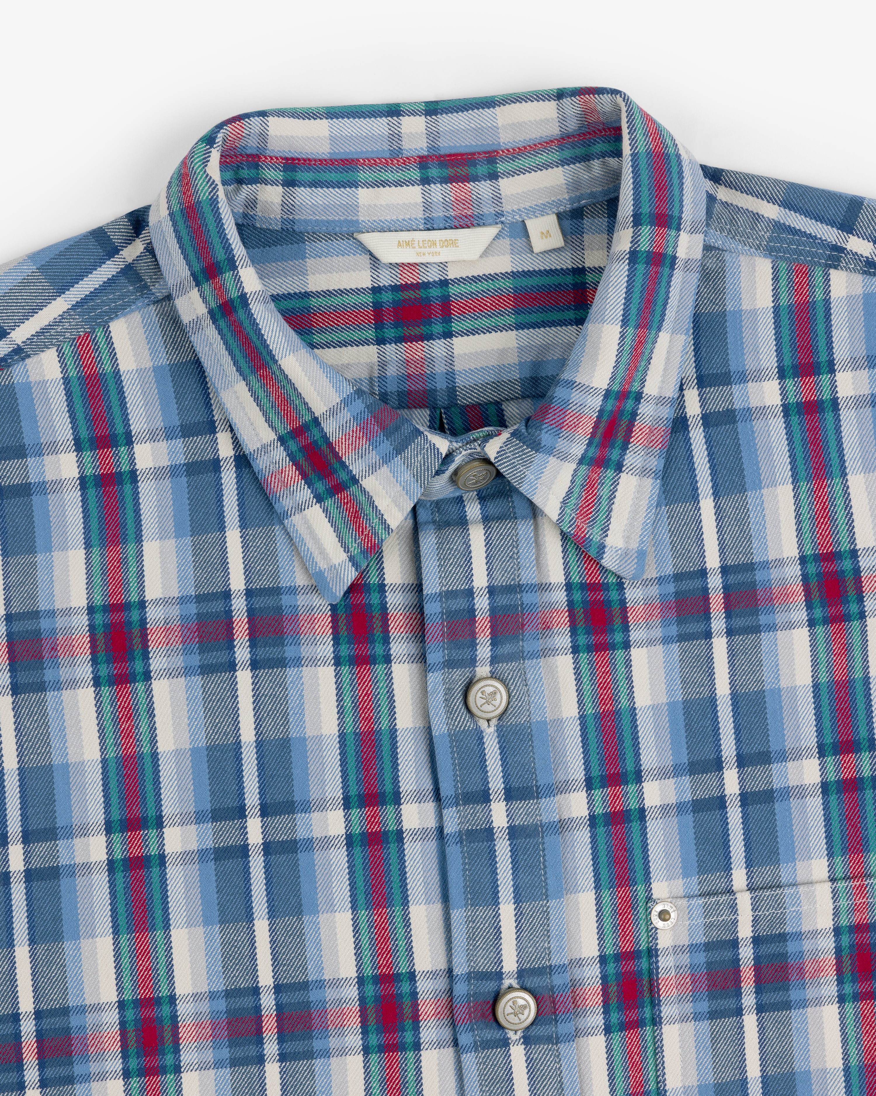 Plaid Work Shirt in blue, white, red, and green, neatly folded to display the collar and buttons.