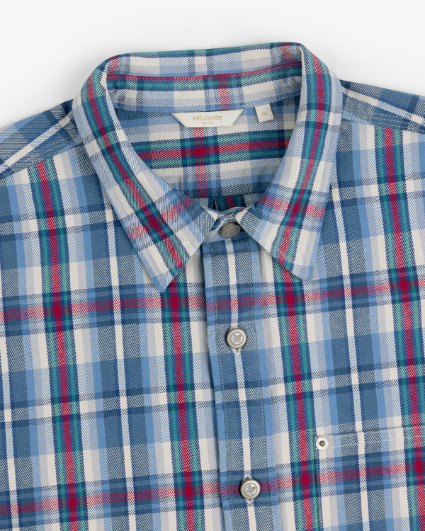 Plaid Work Shirt in blue, white, red, and green, neatly folded to display the collar and buttons.