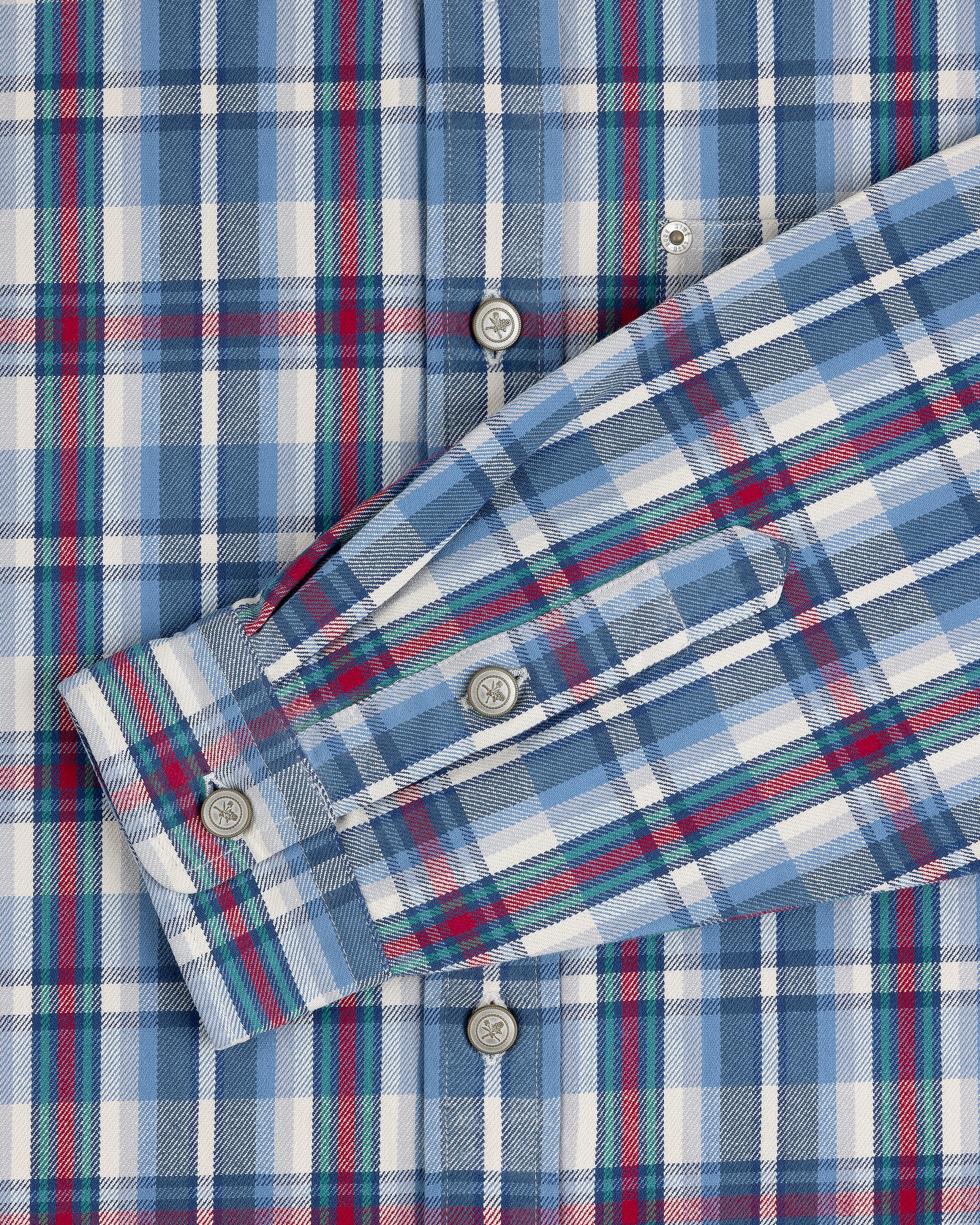 Plaid Work Shirt in blue, white, and red with button details and one sleeve folded across the front.