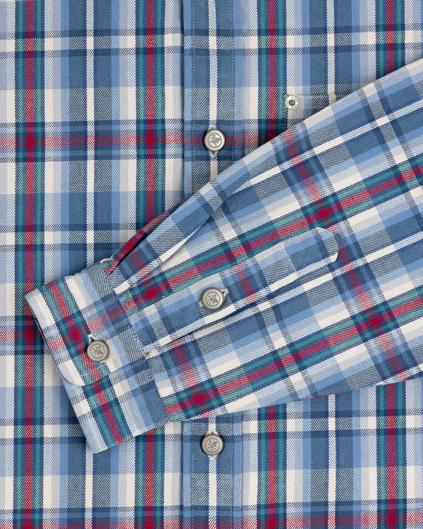 Plaid Work Shirt in blue, white, and red with button details and one sleeve folded across the front.